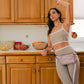woman in kitchen with wellrox Rose multi-pocket fanny-pack worn over her hips, hands free travel purse 