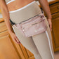 close-up woman with wellrox Rose multi-pocket fanny-pack worn over her hips, crossbody bag for yoga