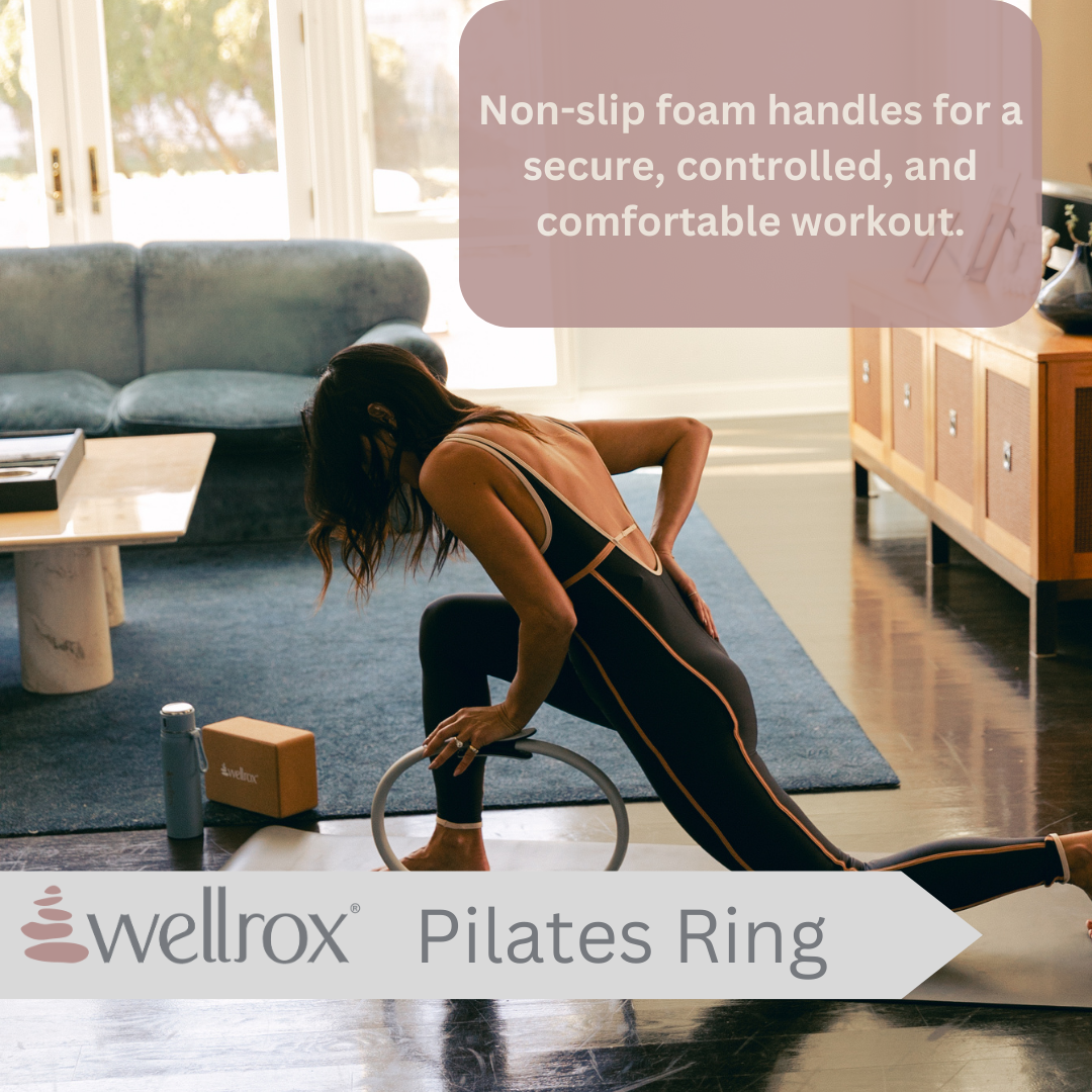 woman toning arms and legs with gray pilates ring showing non-slip foam handles 