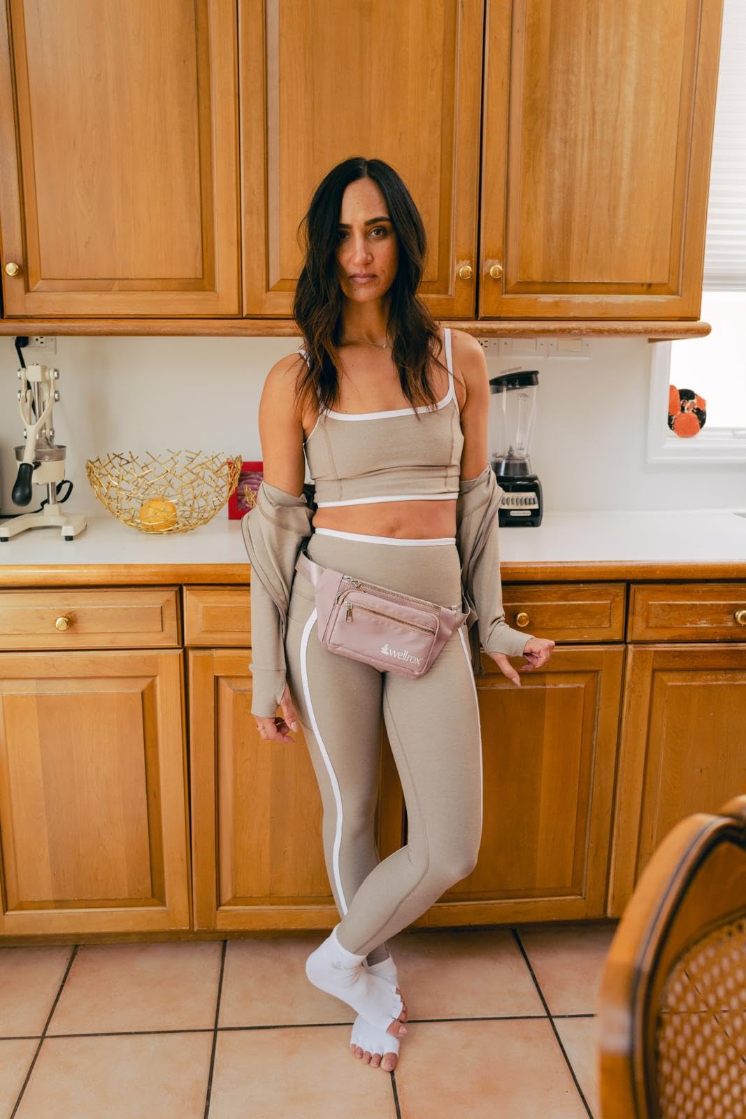 woman with wellrox Rose fanny-pack worn over her hips, small gym bag for women