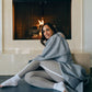 woman wrapped in gray cozy hand-loomed Indian cotton soft machine washable Wellrox yoga blanket , 100% cotton mediation throw