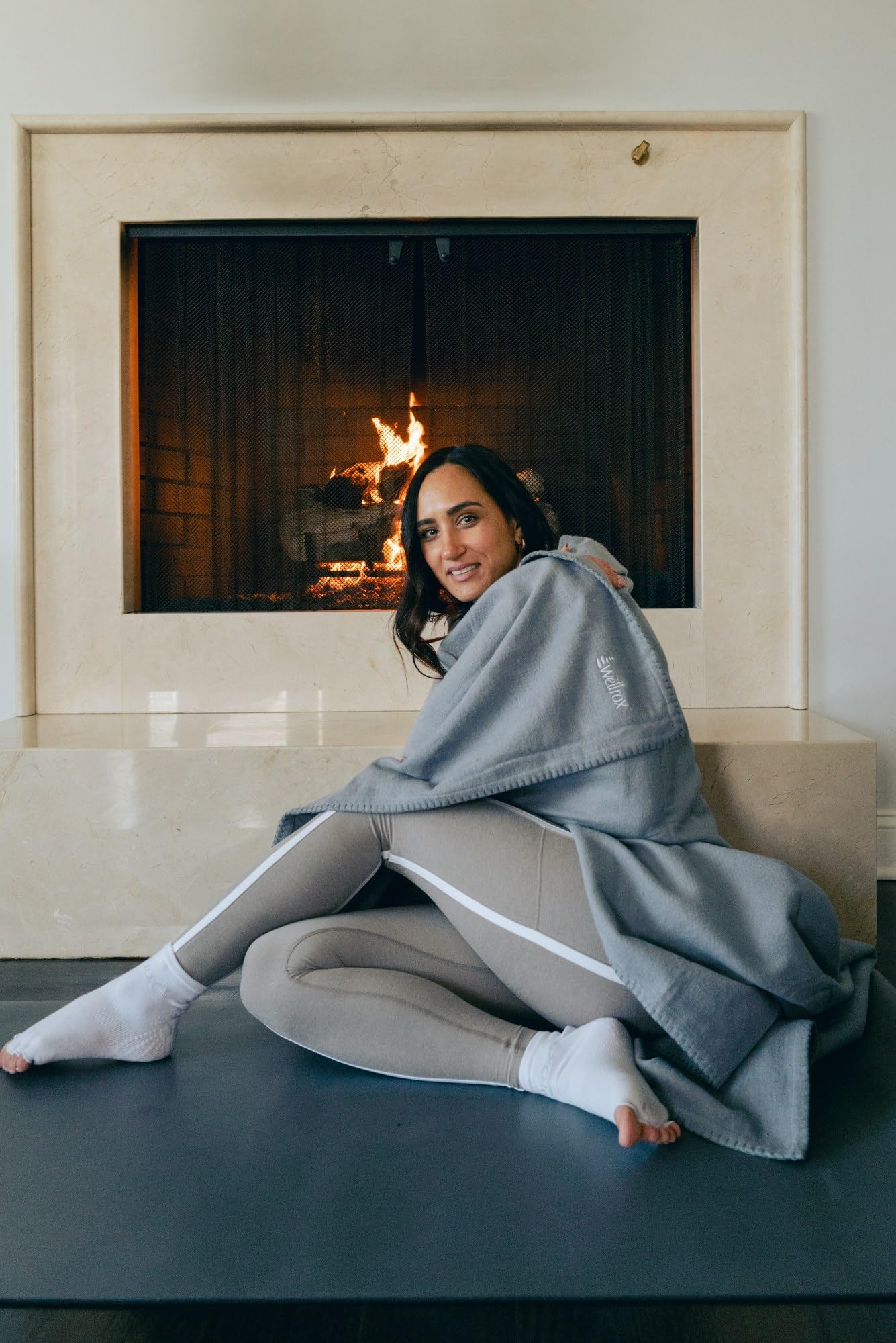 woman wrapped in gray cozy hand-loomed Indian cotton soft machine washable Wellrox yoga blanket , 100% cotton mediation throw